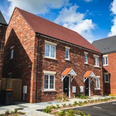 brown brick house under blue sky during daytime